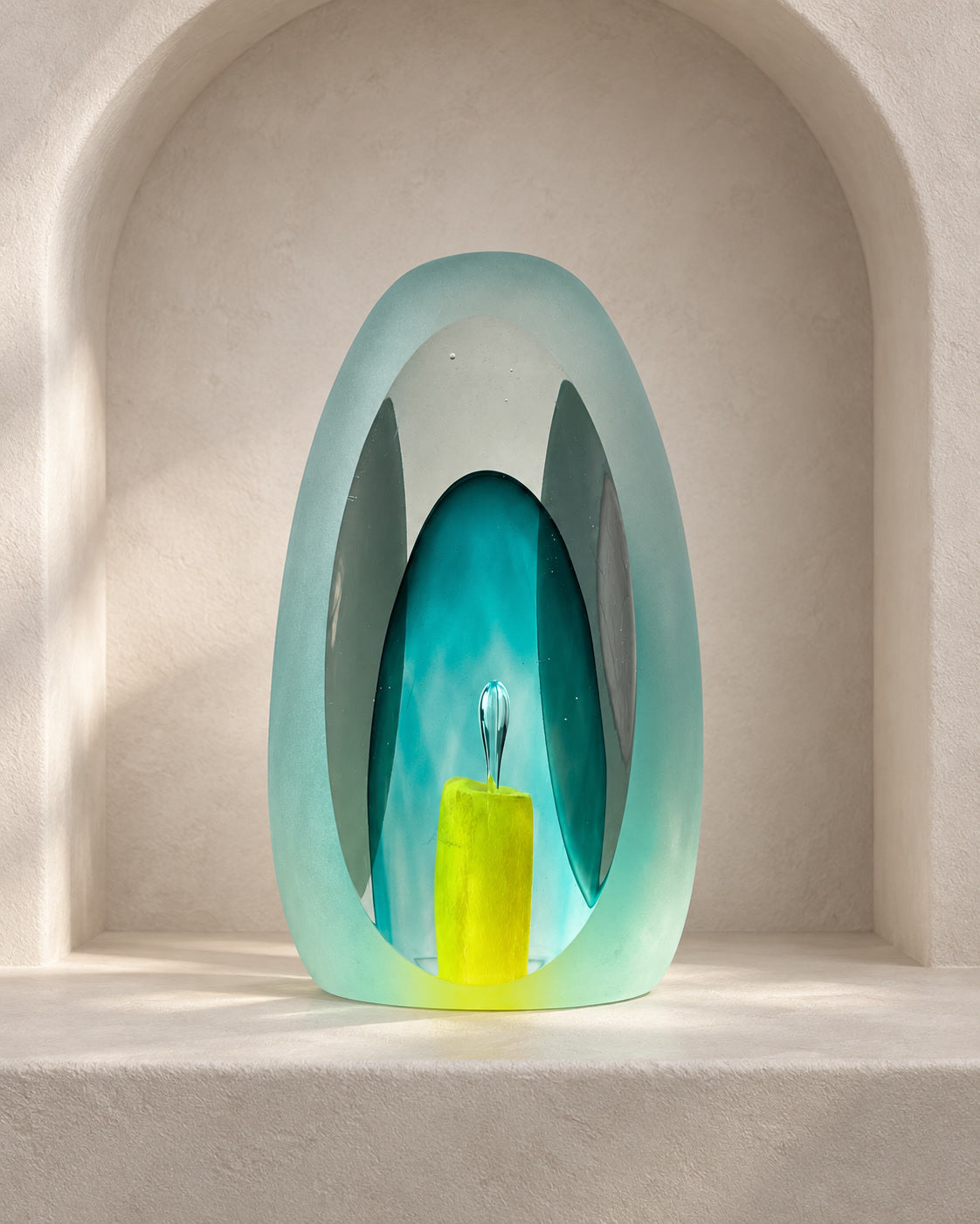 Aqua contemplative glass sculpture in soft meditative light