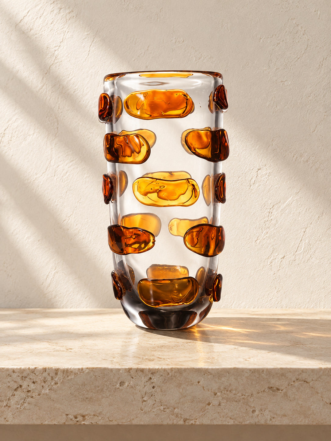 Amber Light glass vase with amber details in a limestone gallery setting