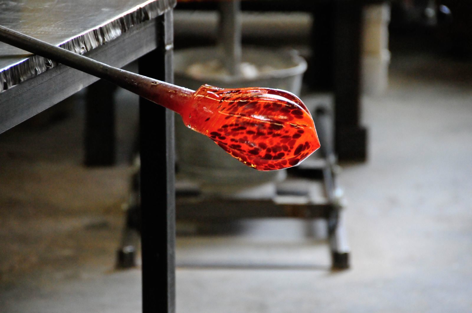 A shaped hot glass vessel with a defined curved profile